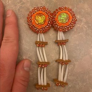 Indigenous made earrings, orange&red beaded with moose hide and dentilum.